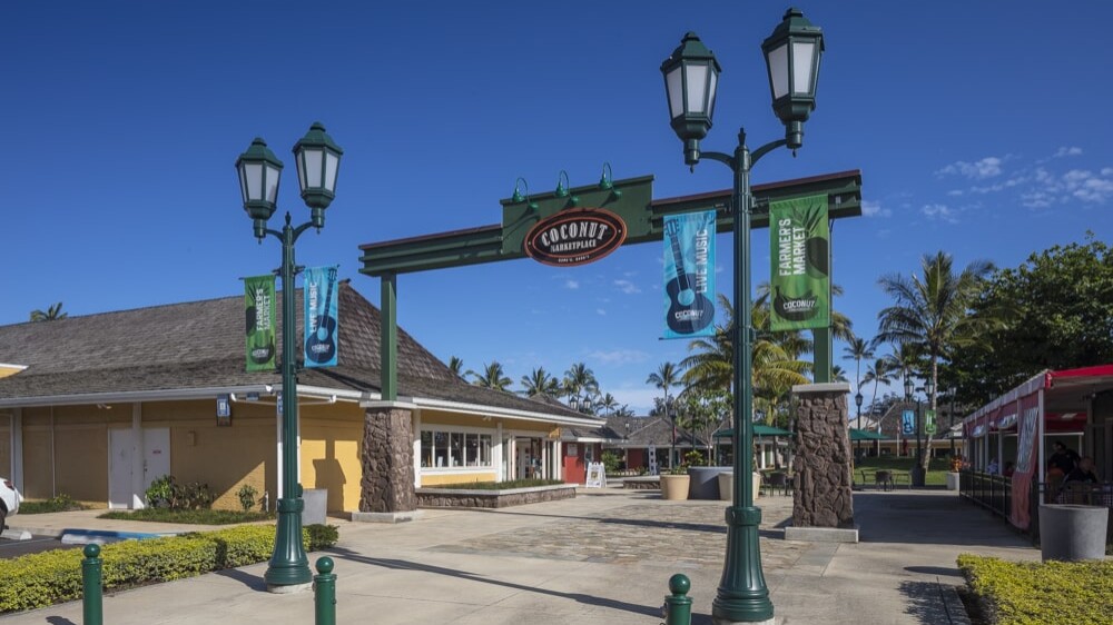 A vibrant sign welcomes visitors to the Coconut Marketplace.