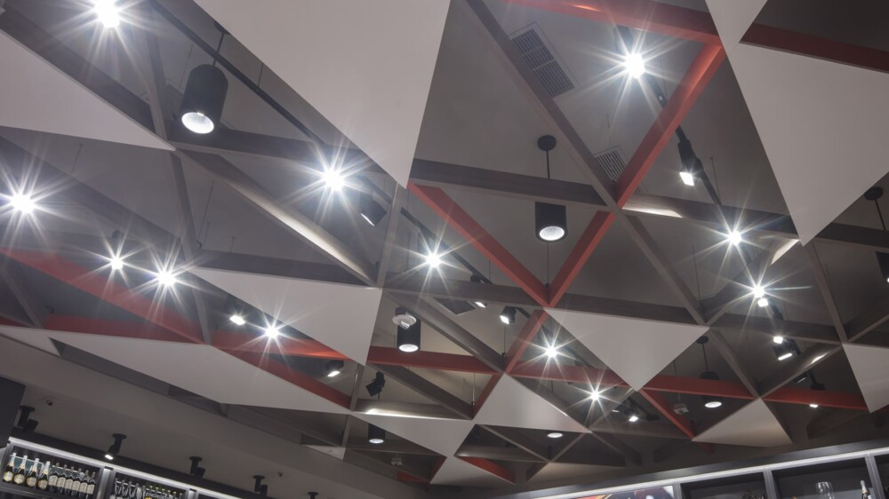 Modern ceiling design with bright lighting.