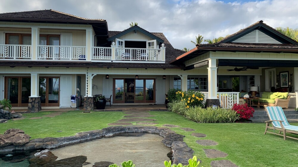 A spacious house with a pool and a well-maintained lawn, offering a perfect blend of comfort and relaxation.