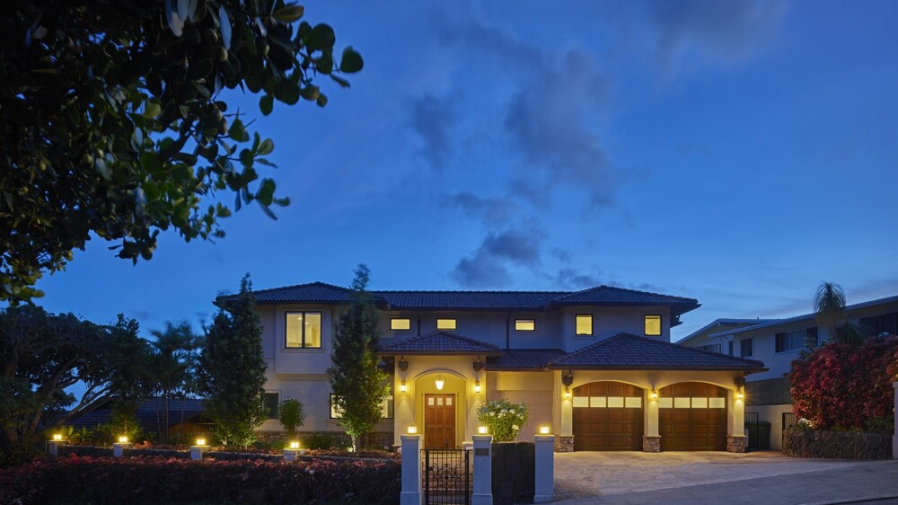 A spacious home with a well-lit driveway, exuding warmth and comfort.