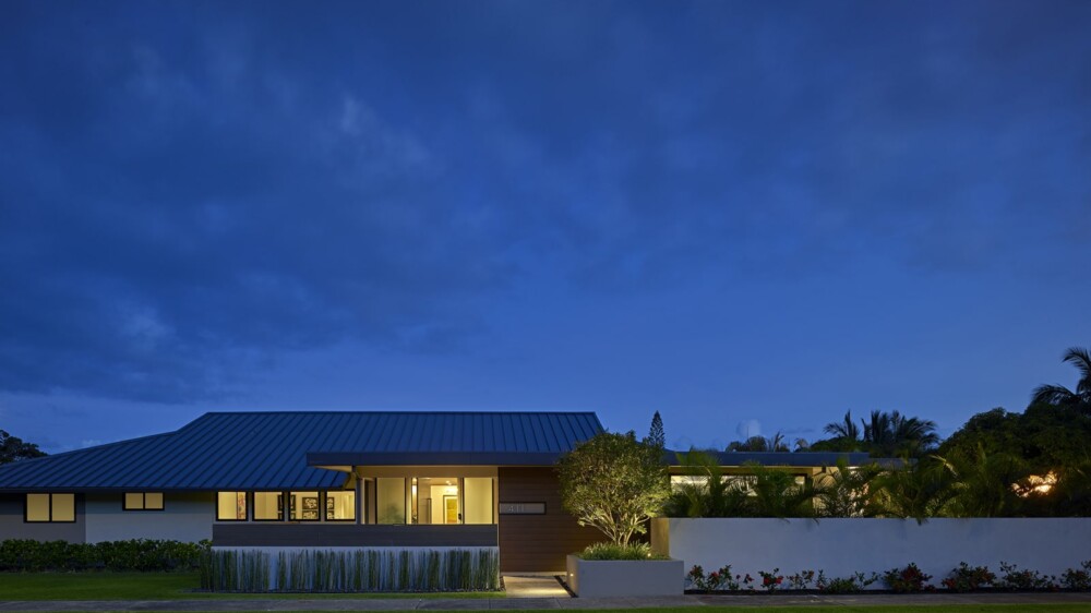 A contemporary house illuminated against the night sky.